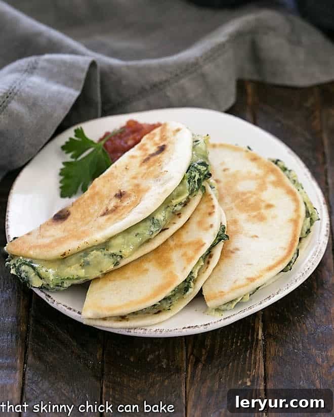 A trio of perfectly cooked, half-moon shaped quesadillas arranged artfully on a white round plate, adorned with a sprig of fresh parsley and a small bowl of vibrant red salsa, ready to be enjoyed.