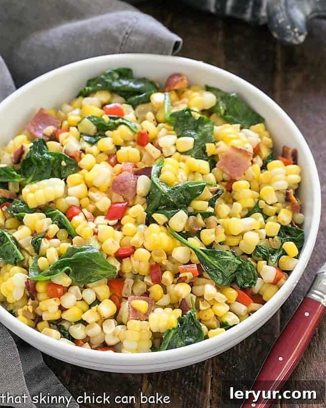 Vibrant Skillet Corn with Spinach and Peppers in a white bowl, viewed from overhead.