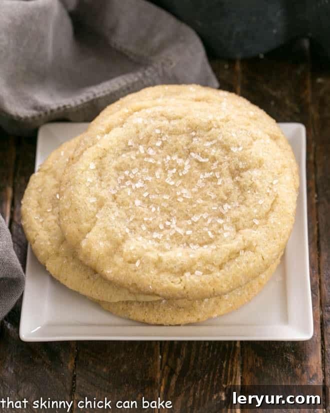 Colossal Sugar Cookies 9 Overhead view of a stack of Big Homemade Sugar Cookies on a square white plate.