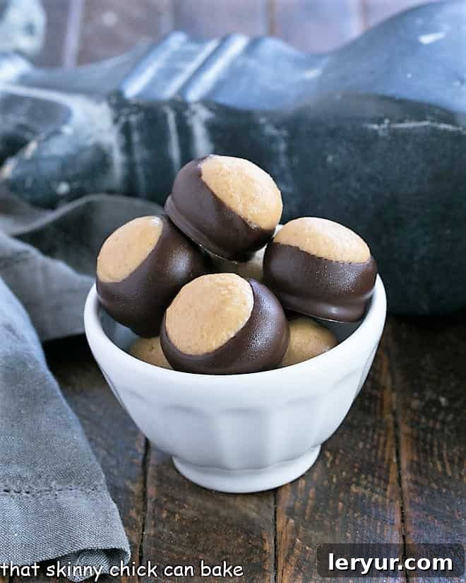 The BEST Chocolate Peanut Butter Balls - AKA Buckeyes are an easy confection with only 6 ingredients! Reeses lovers will go crazy for this Buckeye Recipe! A bowl filled with freshly made Chocolate Peanut Butter Balls, ready to be enjoyed.
