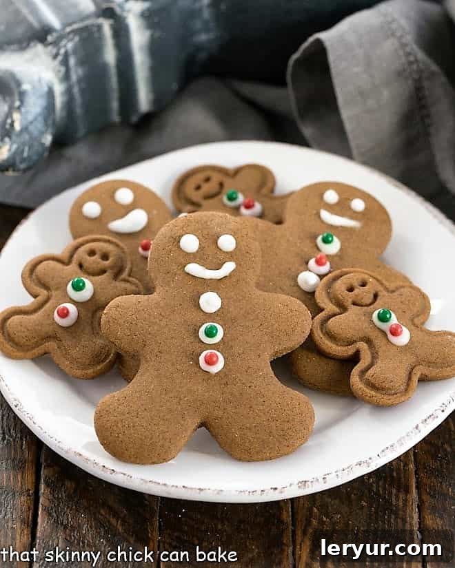 A round white plate beautifully displaying a variety of gingerbread man cookies in different sizes, each with its unique charm.