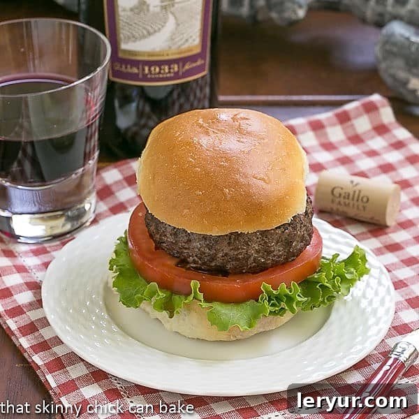 California burger on a white plate over a checked napkin