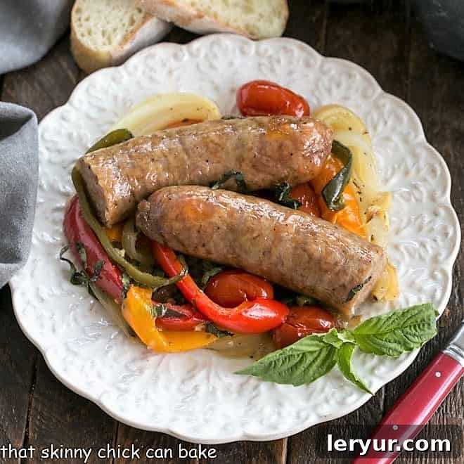 Italian Sausage and Peppers - a roasted version of an Italian-American classic that concentrates the flavor and deliciousness! Serve straight up or in buns for a comforting meal. An overhead view of a generously portioned plate of Italian Sheet Pan Sausage and Peppers, showcasing the vibrant colors and appealing textures of the roasted ingredients.