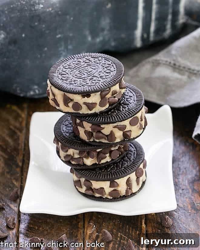 Oreo Cookie Dough Cookies - An easy semi-homemade recipe made with safe, edible cookie dough nestled in an Oreo Cookie A stack of four Oreo Cookie Dough cookies on a rippled square plate, tempting viewers.