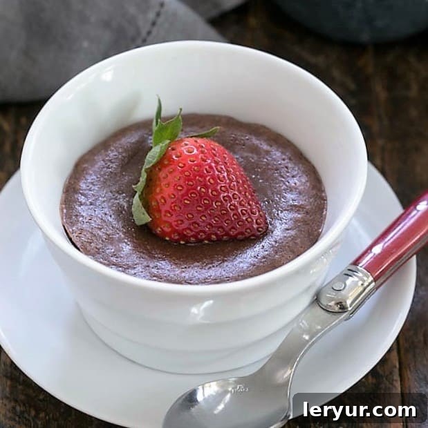 A warm chocolate cheesecake topped with a strawberry
