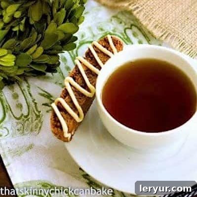 Gingerbread Biscotti - Perfect holiday treats! Gingerbread Biscotti on a teacup saucer, capturing the perfect holiday treat vibe.