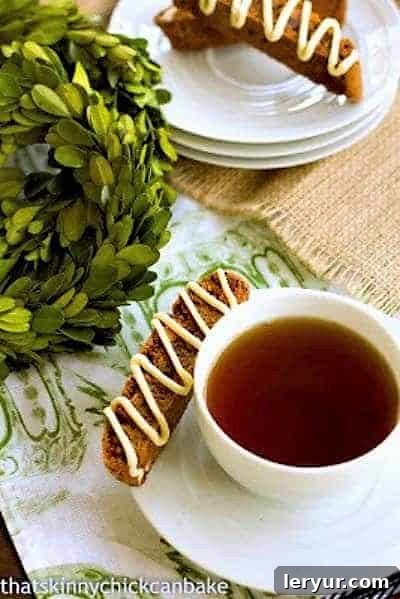 Gingerbread Biscotti - Perfect holiday treats! Gingerbread Biscotti on a stack of saucers with a cup of tea, emphasizing presentation.
