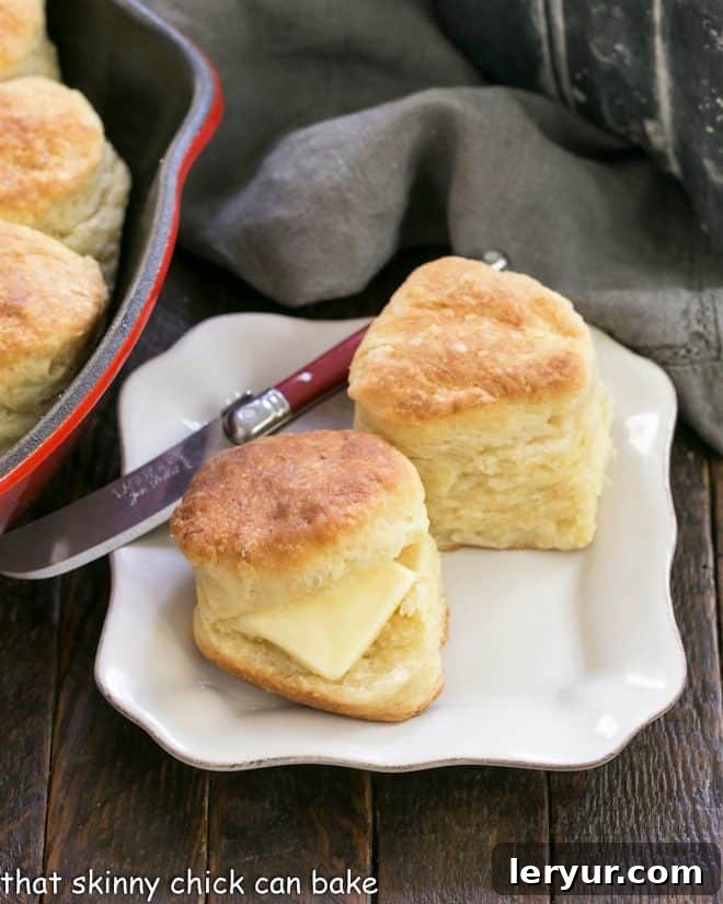 2 angel biscuits on a white plate with a red handle knife