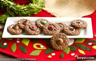 A collection of freshly baked Double Chocolate Thumbprint Cookies arranged neatly on a rectangular white serving tray.