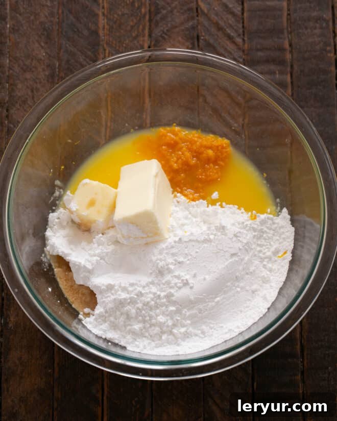 All ingredients for the orange filling and frosting combined in a mixing bowl.
