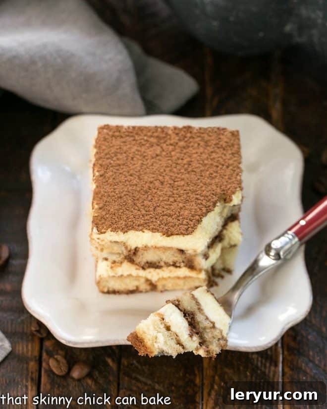 Decadent Tiramisu From Scratch 3 A slice of tiramisu with a forkful removed