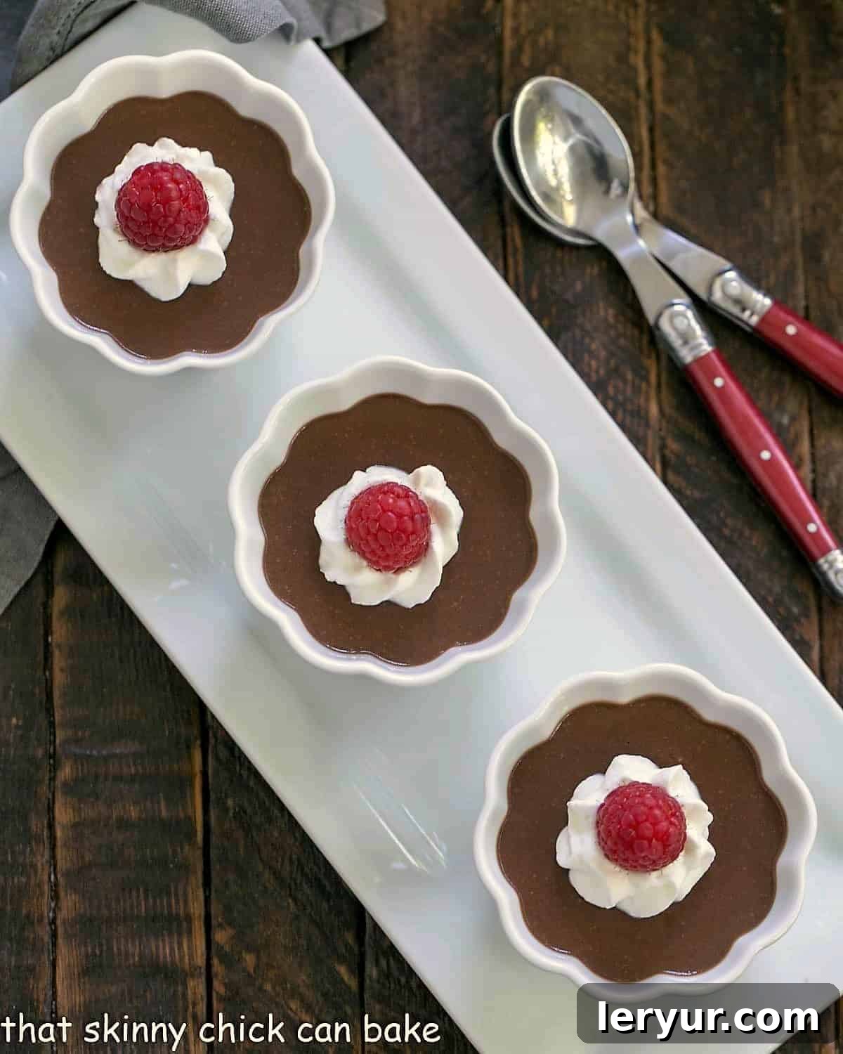 Decadent Italian Chocolate Budino 13 Three elegant ramekins presenting Italian chocolate pudding, arranged on a pristine white ceramic tray, highlighting its rich texture.