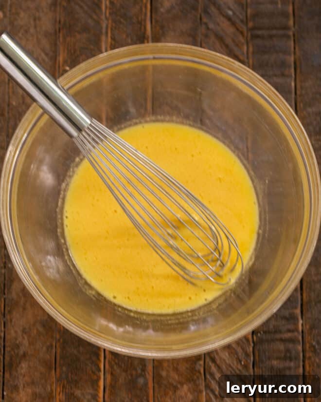 Decadent Italian Chocolate Budino 6 Egg yolks and sugar being whisked together in a bowl until pale.