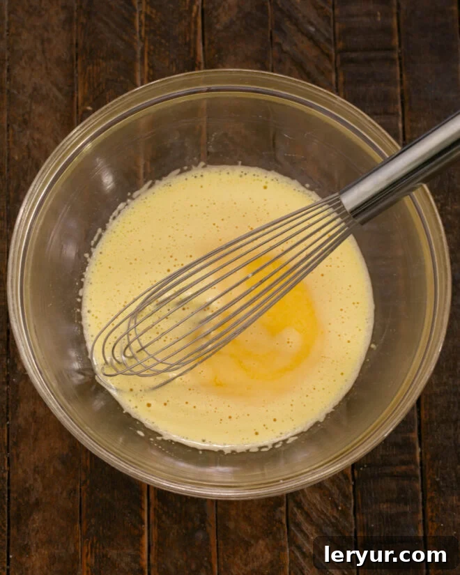Decadent Italian Chocolate Budino 7 Process of tempering egg yolks with hot cream while whisking vigorously, then cooking the custard in a saucepan.