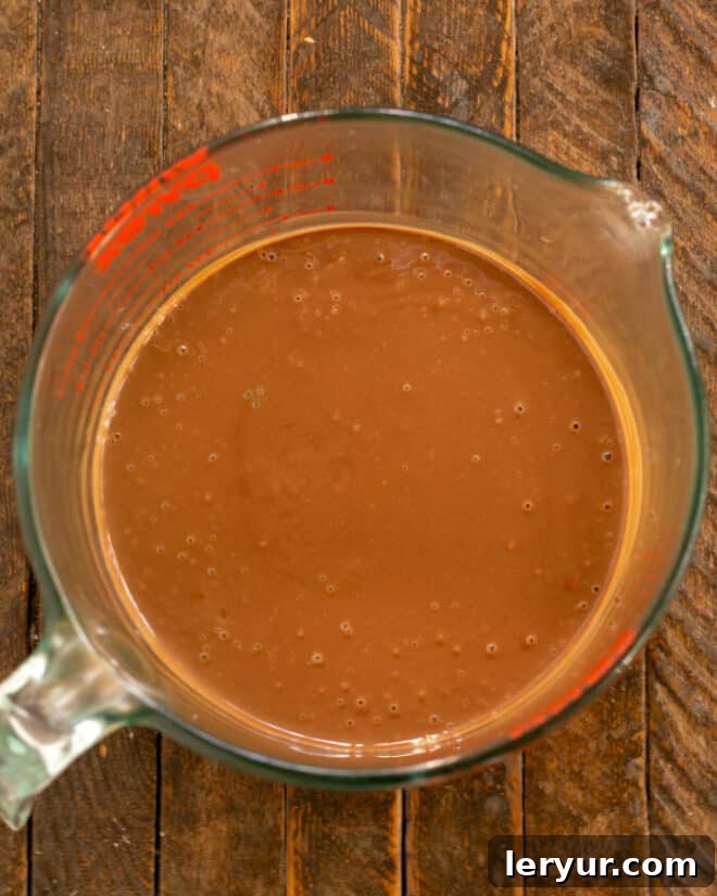 Decadent Italian Chocolate Budino 9 Warm custard being poured over chopped chocolate, followed by stirring until smooth.