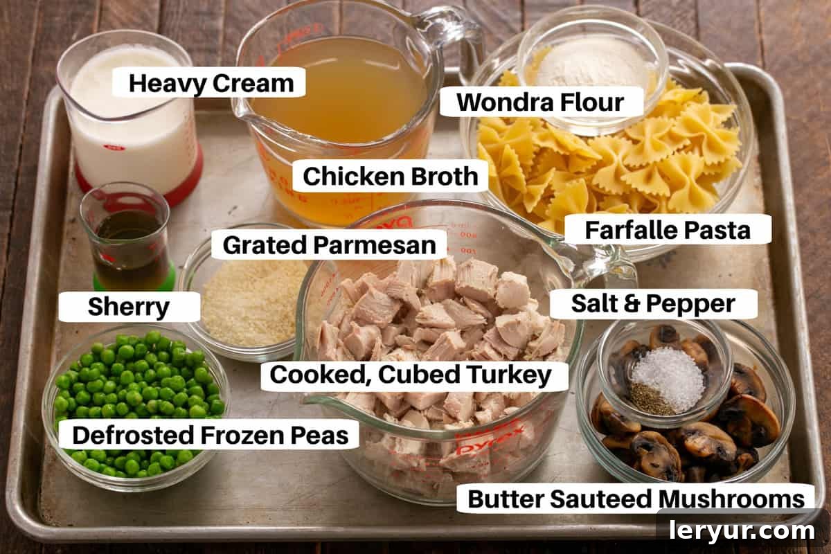 Creamy Homestyle Turkey Tetrazzini 2 Lay out of fresh ingredients for Turkey Tetrazzini on a metal sheet pan, including cooked turkey, pasta, mushrooms, peas, and cheese.