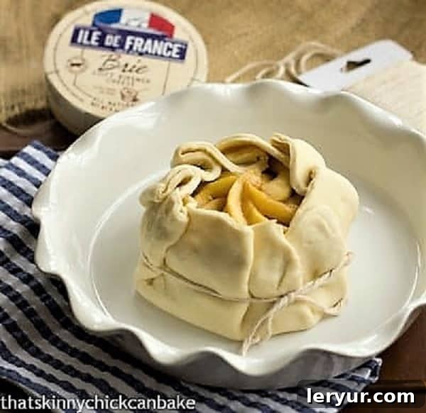 Apple Baked Brie en Croute - an elegant baked brie appetizer that will get rave reviews Apple Topped Baked Brie en Croute ready for the oven, showcasing the folded puff pastry