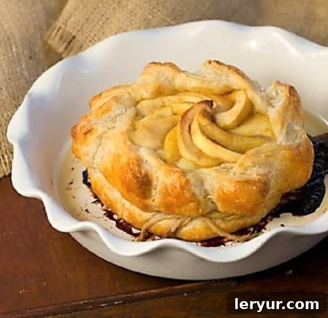 Apple Baked Brie en Croute - an elegant baked brie appetizer that will get rave reviews Apple Baked Brie in a white baking dish, golden and perfectly puffed