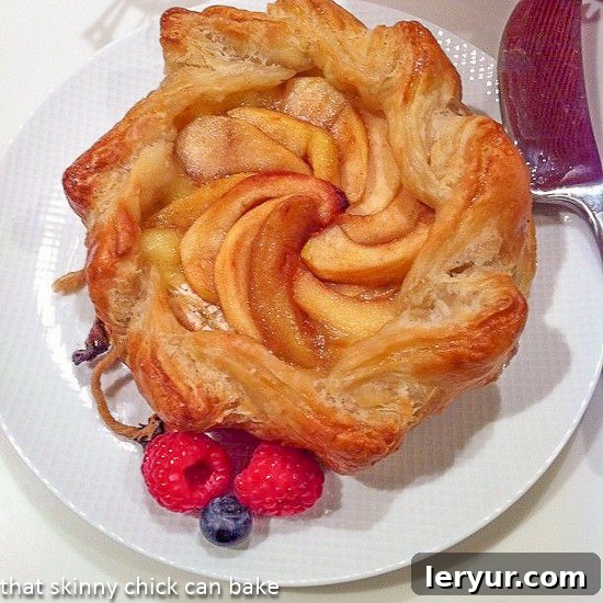 Overhead view of apple topped bake brie, golden brown and garnished