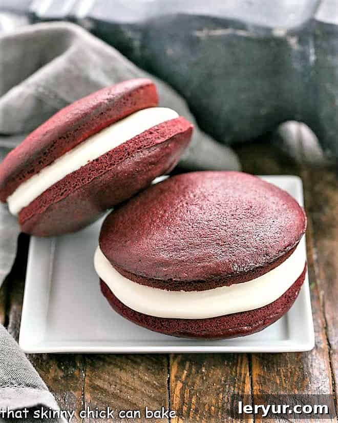 Plush Red Velvet Whoopie Pies 3 Two whoopie pies stacked on a square white plate, highlighting their height and generous filling.