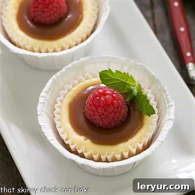 Close overhead view of mini cheesecakes topped with caramel and mint, elegantly arranged for a dessert presentation.