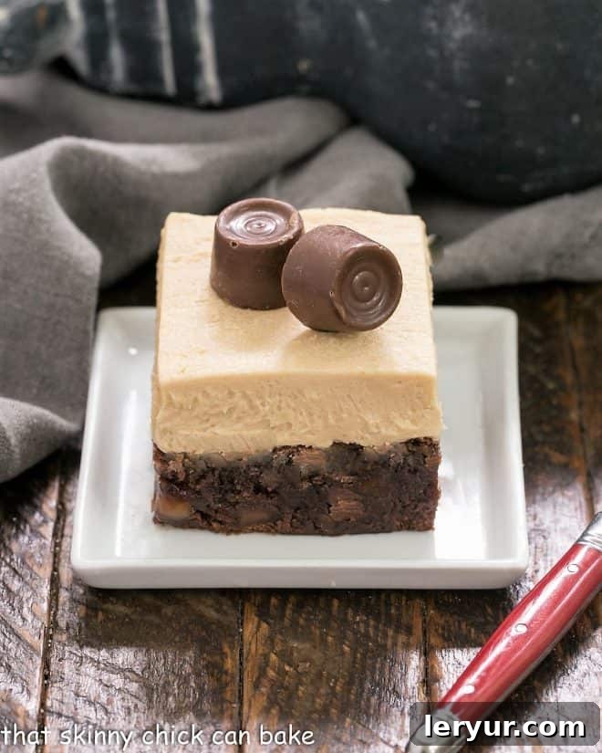 A perfectly portioned Caramel Brownie square with a thick layer of creamy caramel buttercream, presented beautifully on a white dessert plate.