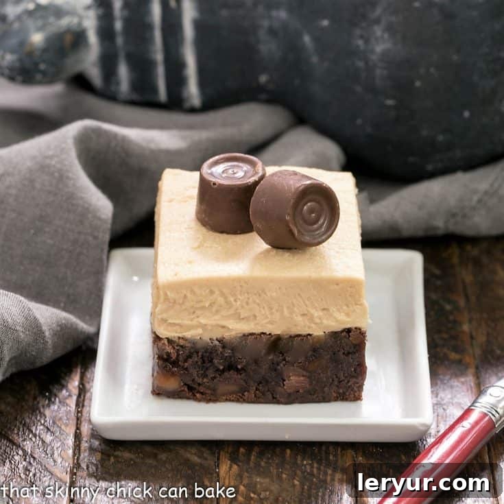A beautifully presented caramel brownie with caramel buttercream on a square white plate, accompanied by a red-handled fork, inviting indulgence.
