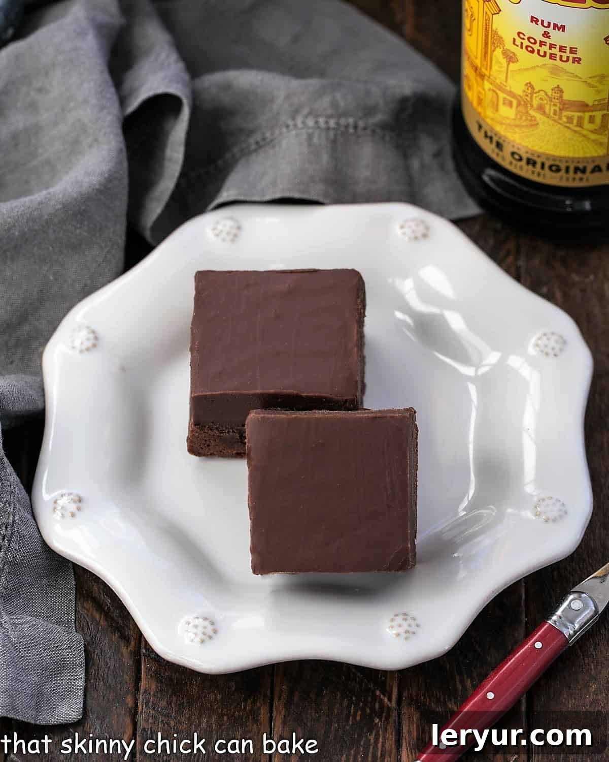 Decadent Kahlua Fudge Brownies 3 Overhead view of two squares of Kahlua fudge brownies, showcasing their thick fudge topping and moist texture.