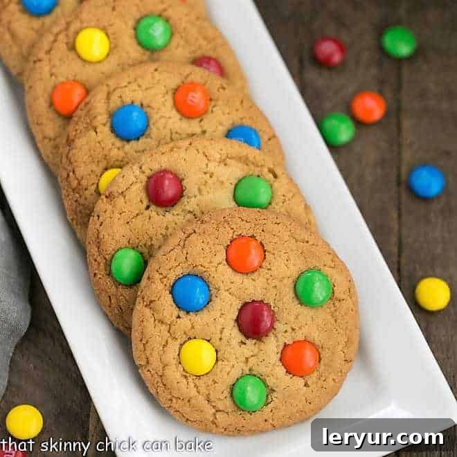 Classic M & M Cookies artfully arranged on a white ceramic tray, highlighting their deliciousness.