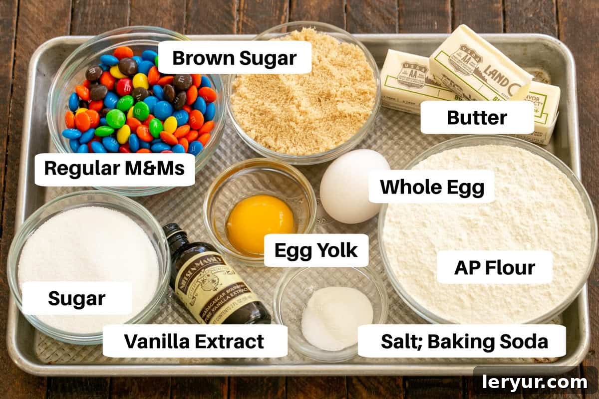 M&M Cookie Ingredients neatly arranged on a sheetpan with labels, ready for baking.