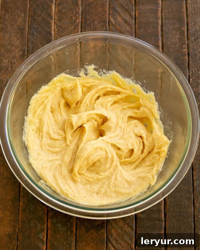 Step 2: Add egg and egg yolk to the creamed mixture and mix until just combined.