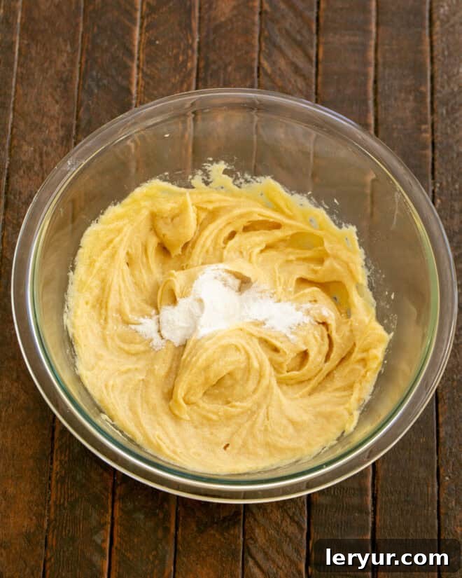 Step 3: Mix in vanilla extract, then baking soda and salt into the wet ingredients.