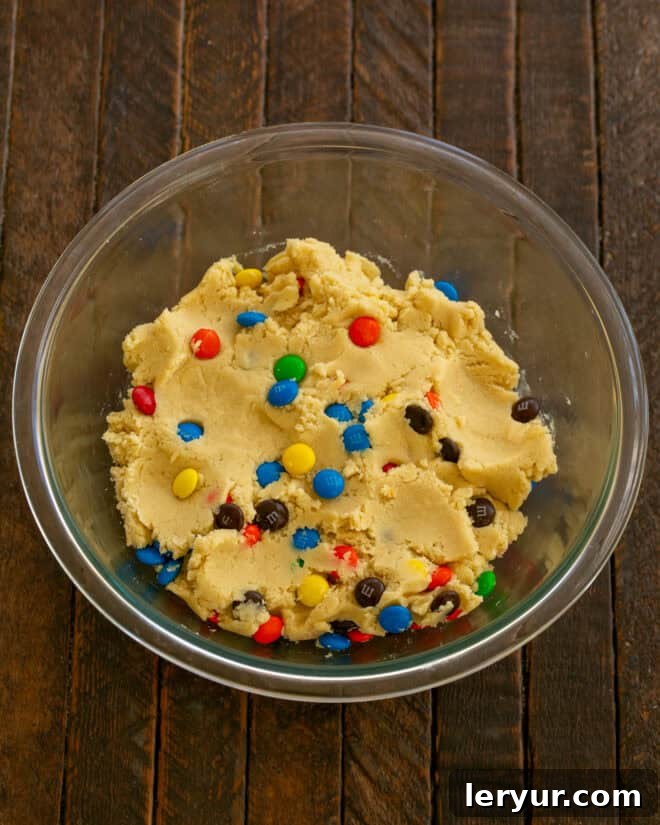Step 4: Gradually mix in flour, then fold in the M&M's candies.