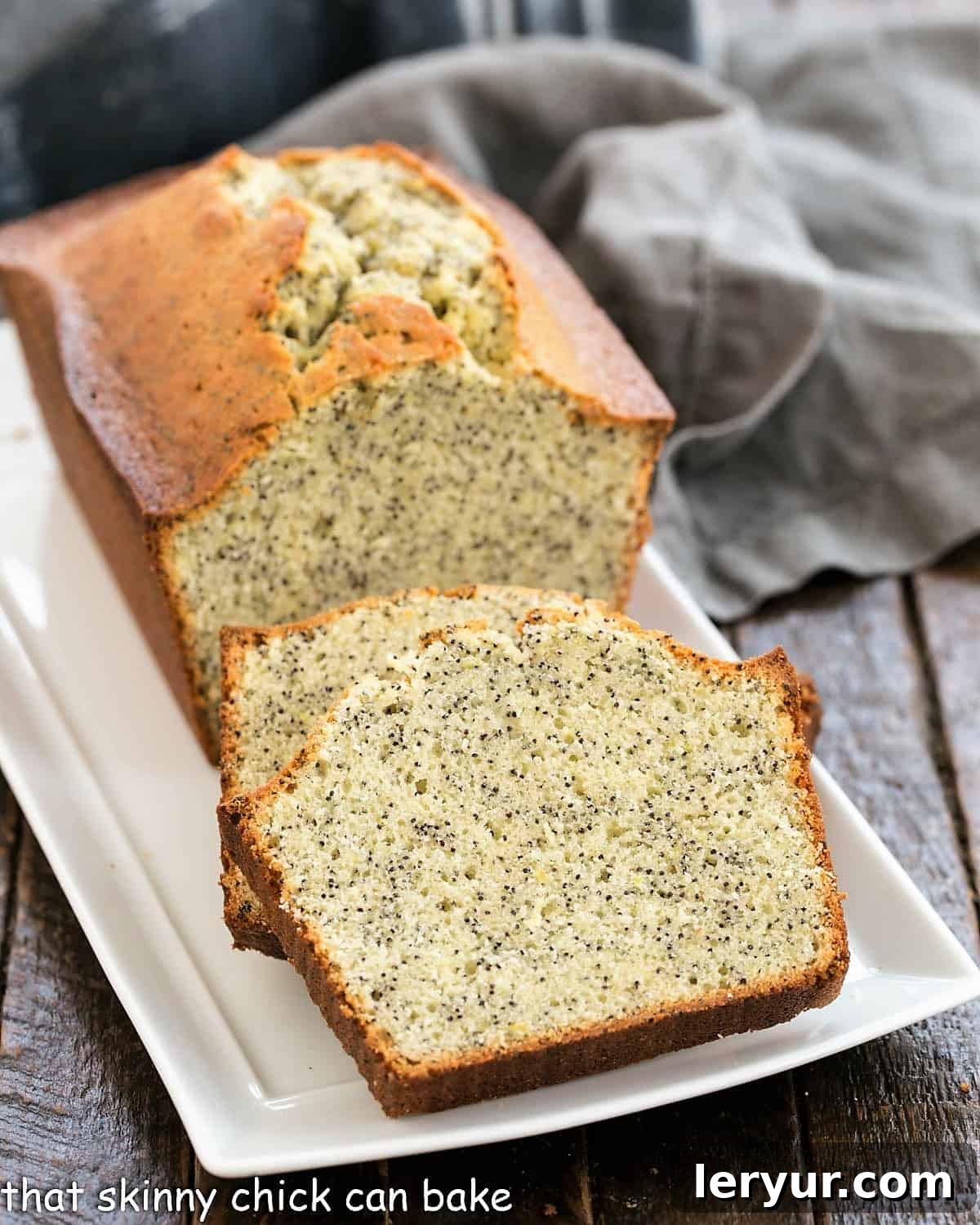 Sun-Kissed Lemon Poppy Seed Loaf 2 Sliced lemon poppy seed loaf on a ceramic tray.